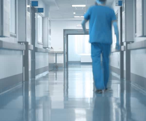 Doctor Walking Down Hospital Halls