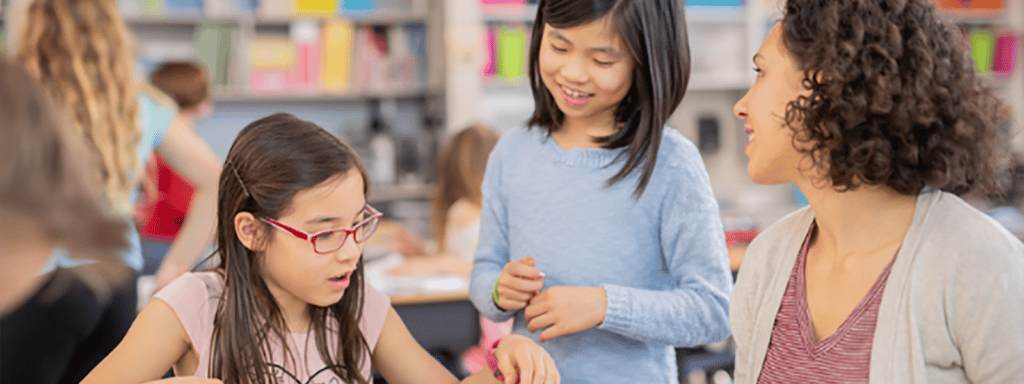 Teacher with students in library