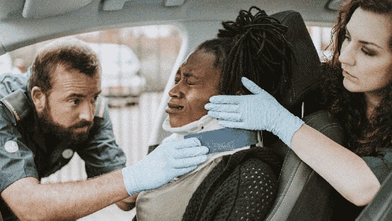 EMTs treating car crash victim