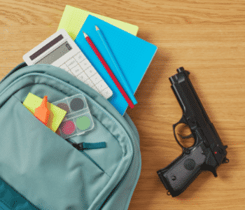 School Backpack on Desk with Gun