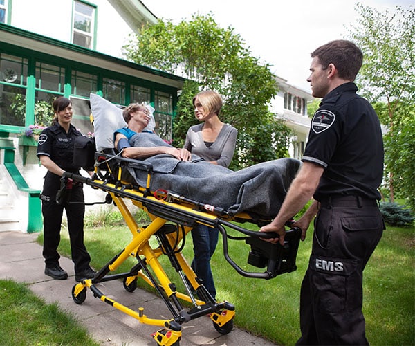 EMS Providers transporting patient on stretcher