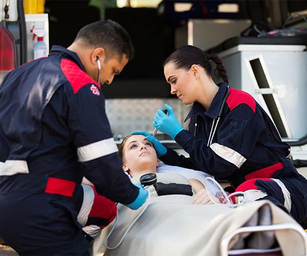 EMS providers treating patient on stretcher