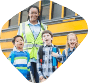 A security officer ushering school children into their school bus