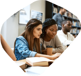 Two girls studying together in a library