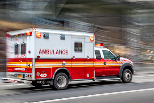 Ambulance driving down street with controlled substance tracking software to mitigate risk.